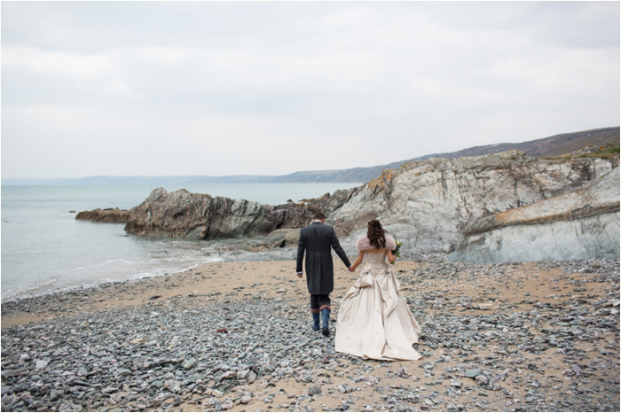 A bride and groom walking on the beach in Cornwall Wedding Photographer in Cornwall